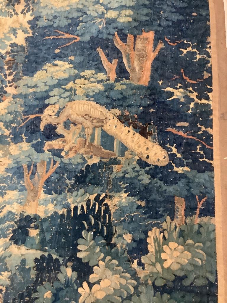 An early 17th century Aubusson tapestry, worked with a peacock in a landscape (worn in places and reduced)